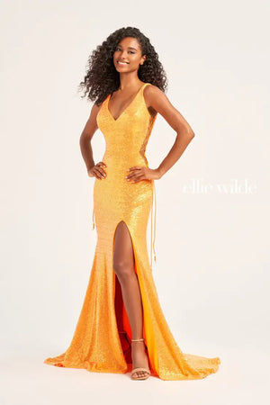 Feel like you're walking the runway in this incredible dress by Ellie Wilde, style EW35235. This vibrant dress comes in multiple colors such as orange, Fuchsia/hot pink, and a stunning shade of light blue. The fabulous sequins details and V-shaped neckline are a must have when choosing your dream prom dress and the long train with a slit is just an incredible bonus.