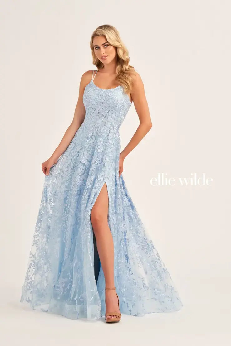 Dance the night away in this delightful a line dress Ellie Wilde dress EW35222. This romantic gown features an elegant scoop neckline and dainty thin double strap. Flattering on all, this enchanting gown accentuates your waistline highlighting your silhouette. Gleaming delicate lace embroidery adorns the entire silhouette giving this dress the perfect pop of sparkle. The playful skirt showcases a high appealing slit and flirty side pockets that add a charismatic touch.
