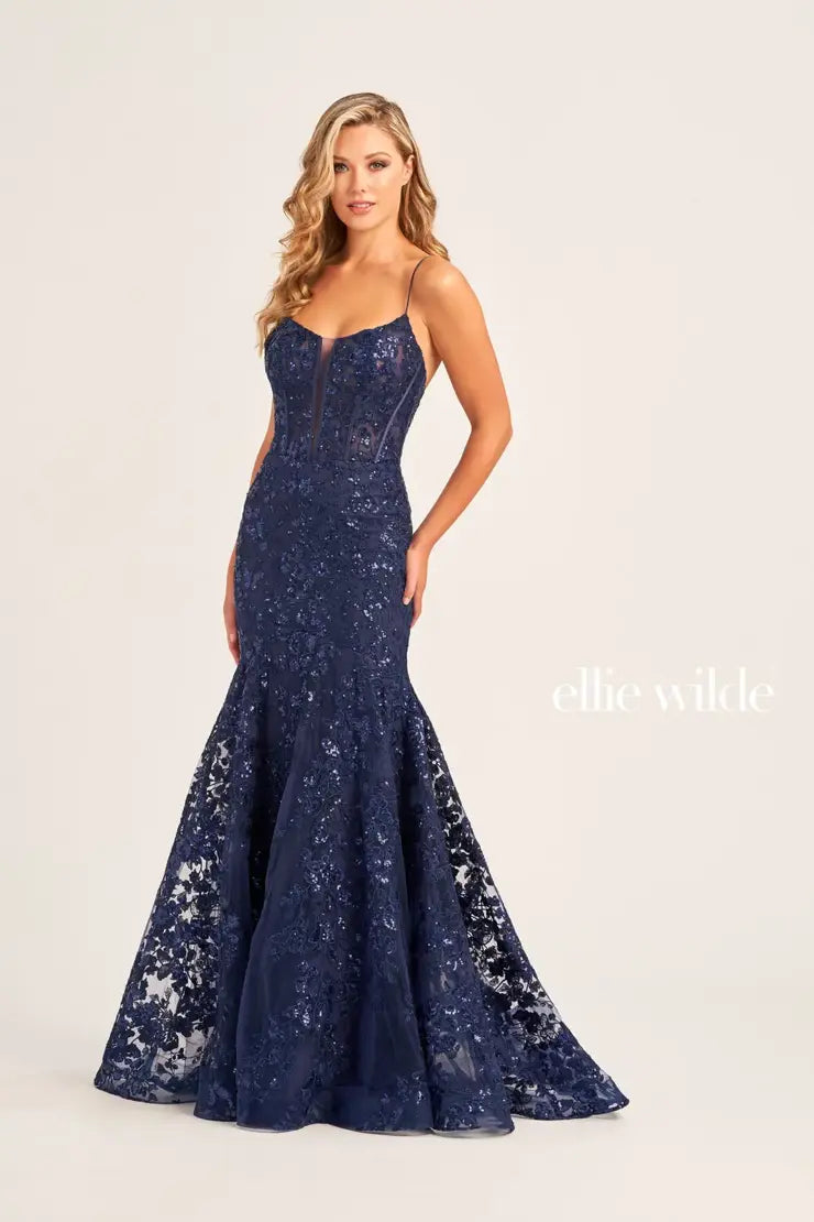 Sparkle from head to toe in this vivacious Ellie Wilde prom dress EW35203. From the scoop neckline down to the sweep train, dazzling combinations of embroidery, beads, and sequins create shimmering patterns that will have you sparkling from any angle. The fitted corset bodice cinches your upper body and the skirt is completed with a sweep train.