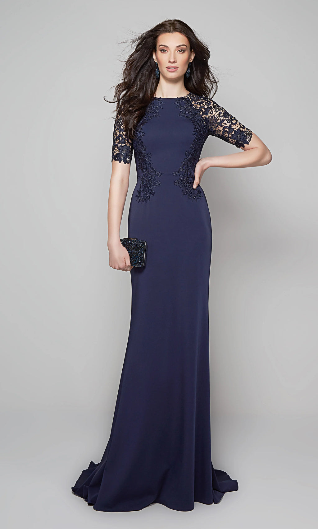 This Alyce Paris 27585  mother of the bride dress is styled in stretch crepe with lace accents, with a jewel neckline and short sleeves. This slim-flare formal gown exits with a partial illusion back and a sweep train