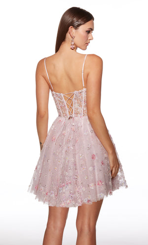 Woman wearing a floral lace dress with thin straps on a white background