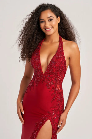 Look sizzling hot at prom in this haute Colette fitted dress style CL5206 made in curve hugging stretch jersey material adorned with beaded lace appliques sequins and sparkling heat set stones. This phenomenal style features a halter strap bodice with deep V neckline and low back with a zipper closure and cut out. The long slim skirt has a sexy high front side slit and sweep train.