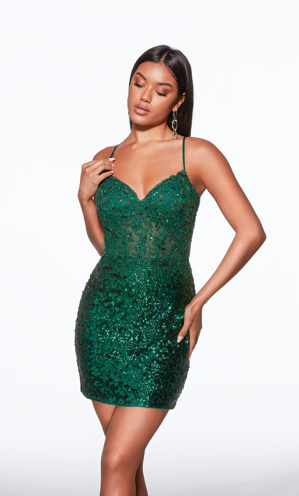 Woman wearing a green sequin dress on a white background