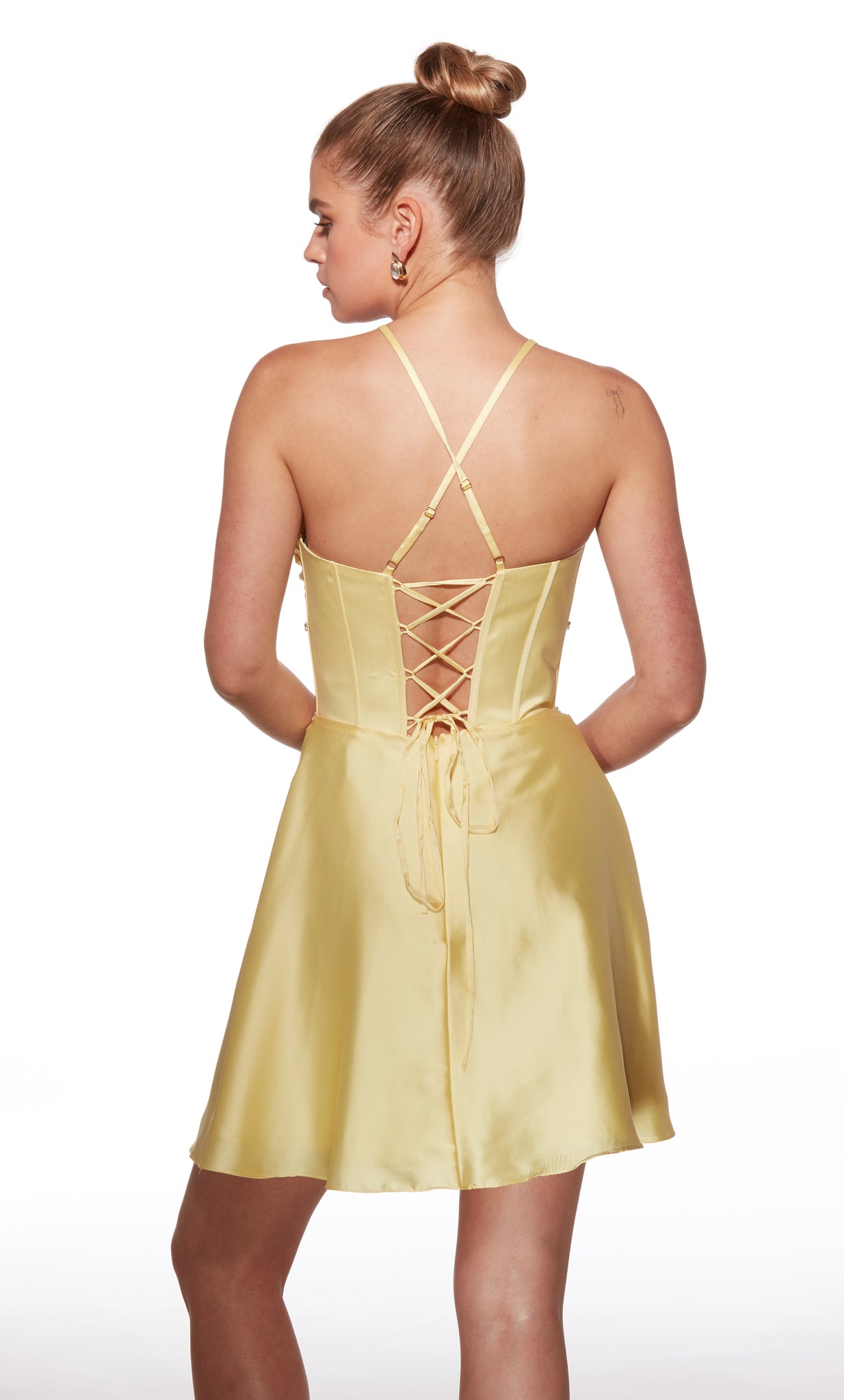 Yellow dress with criss-cross back design on a white background