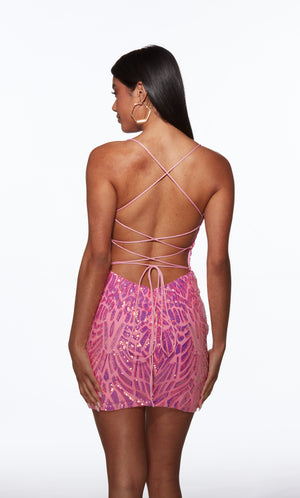 Woman wearing a pink dress with a backless design on a white background
