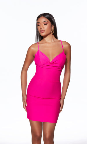 Woman wearing a bright pink dress on a white background
