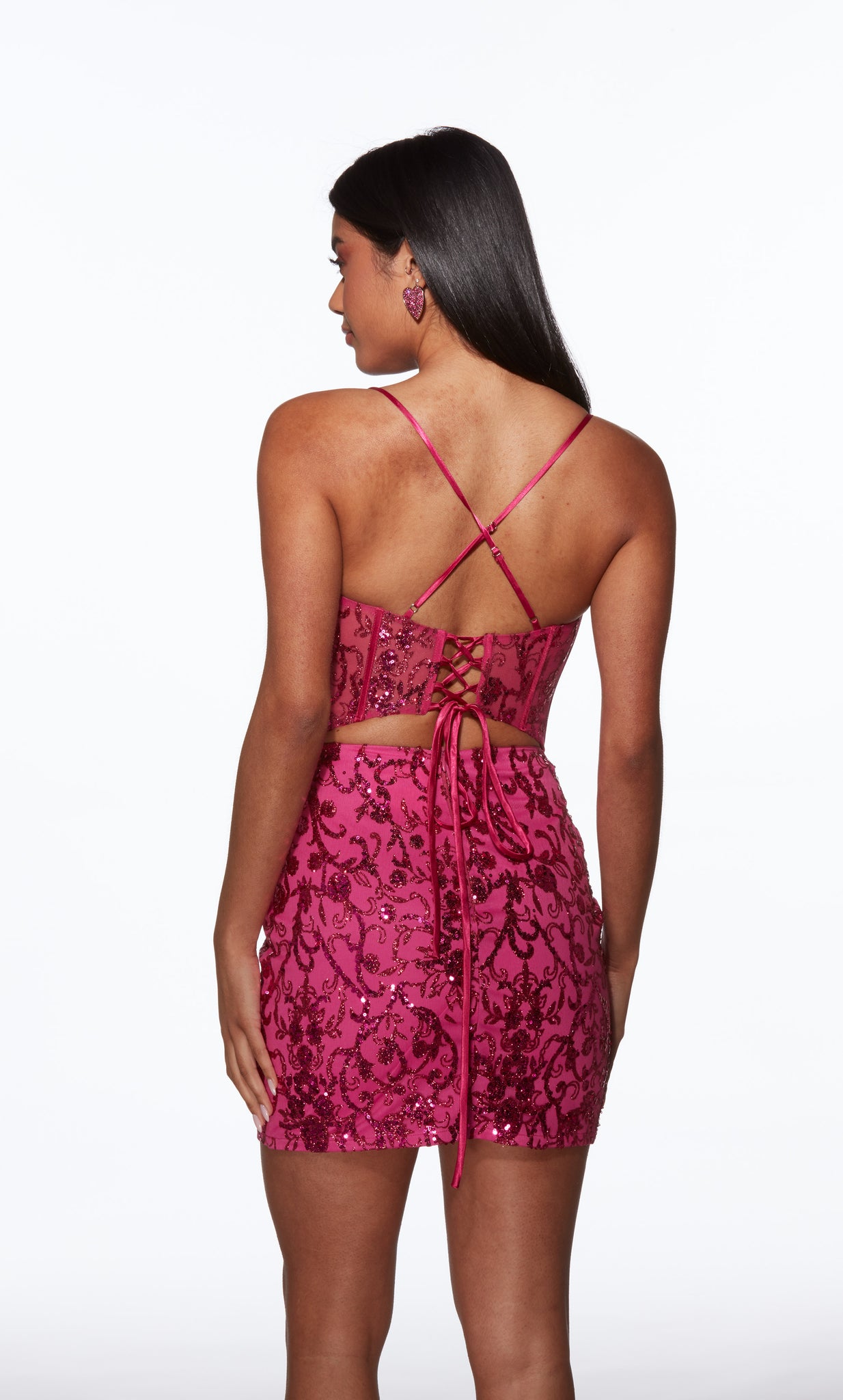 Woman wearing a pink lace-up dress with a white background