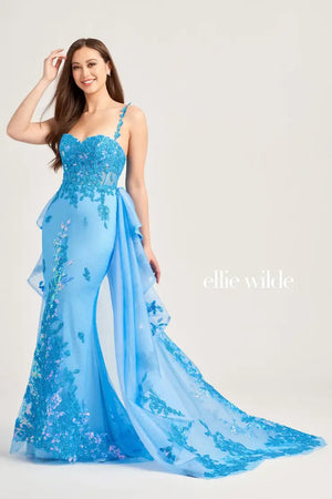 Exude confidence in this remarkable Ellie Wilde gown EW35207. Delightful and exuberant, this shimmering dress features a sweetheart neckline and dainty shimmering thin straps. Gleaming lustrous appliques adorn the corset bodice and gracefully transitions onto the fitted skirt. Picture perfect, the extravagant detachable train highlights lovely scalloped trimming that is the epitome of perfection.