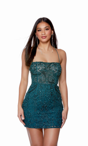 This cocktail dress has a straight across neckline, thin straps, and lace-up back for a snatched waist. The illusion top has exposed boning and is adorned with sparkly crystal embellishments.