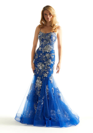 Make a lasting impression in this gorgeous Morilee mermaid dress 48029. This sheer illusion bodice has a scoop style neckline with thin shoulder straps that turn into an adjustable criss cross over your open back. The stunning floral appliques are adorn with sparkling beadwork. The mermaid style skirt trickles down those appliques completing this ultra glam look.