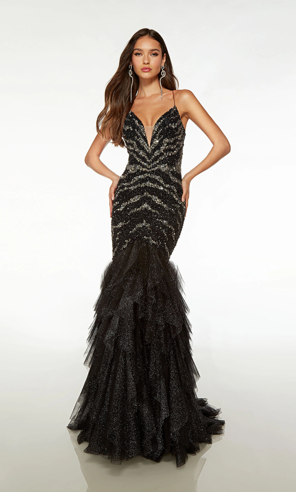 Be the most memorable in this unforgettable Alyce Paris black mermaid prom dress 61721. The fitted silhouette can be further cinched to your liking with the popular corset lace up featured on the back and shimmering combinations of black and silver beadwork adorn the bodice. Ruffled glitter tulle creates the mermaid sweep train.