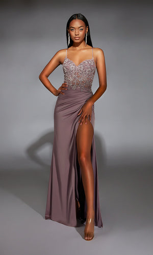 Feel sophisticated in this elegant long dress by Alyce Paris, style 61741. Showcasing a fitted silhouette with a modest v neckline that has delicate satin straps that lead to sa corset lace up back. The corset bodice is fully adorned with glistening beadwork and lace detail. A chiffon skirt has a thigh high slit.