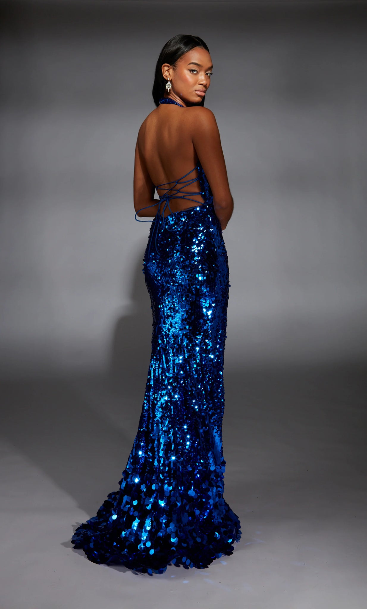 Sparkle at Prom in this glamorous long dress b y Alyce Paris, style 61759. Featuring a fitted silhouette with a plunging v halter neckline. This number is fully embellished with glistening sequins and dazzling beadwork. A thigh high slit and a sexy open lace up back are the prefect final touches.