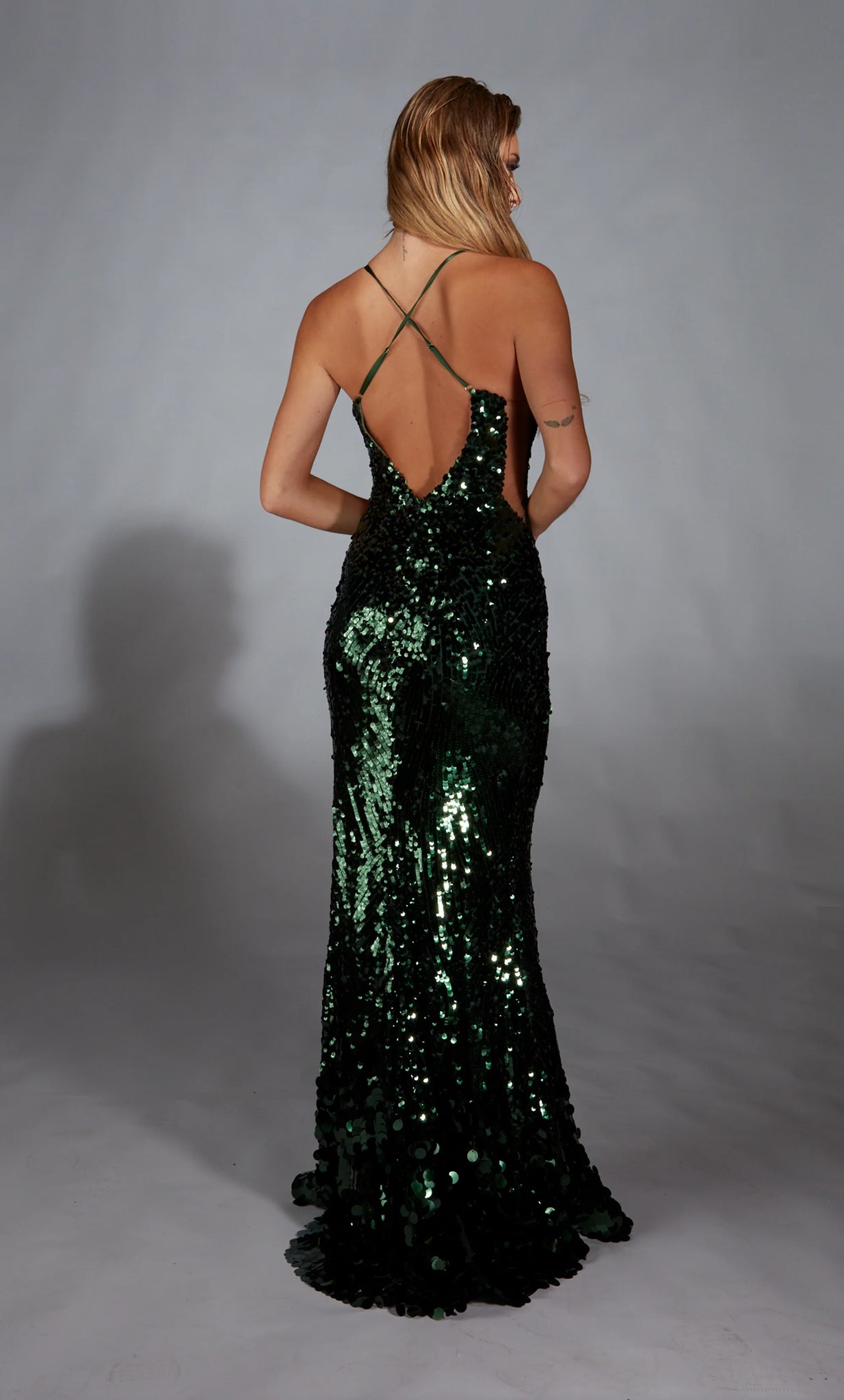 Stand out effortlessly wearing Alyce Paris long dress 61765 for your special event. This form fitting silhouette showcases a classic v neckline paired with simple straps leading into a crisscross open back. Completely decked out in dazzling sequins, this style features a thigh high slit and sweep train.