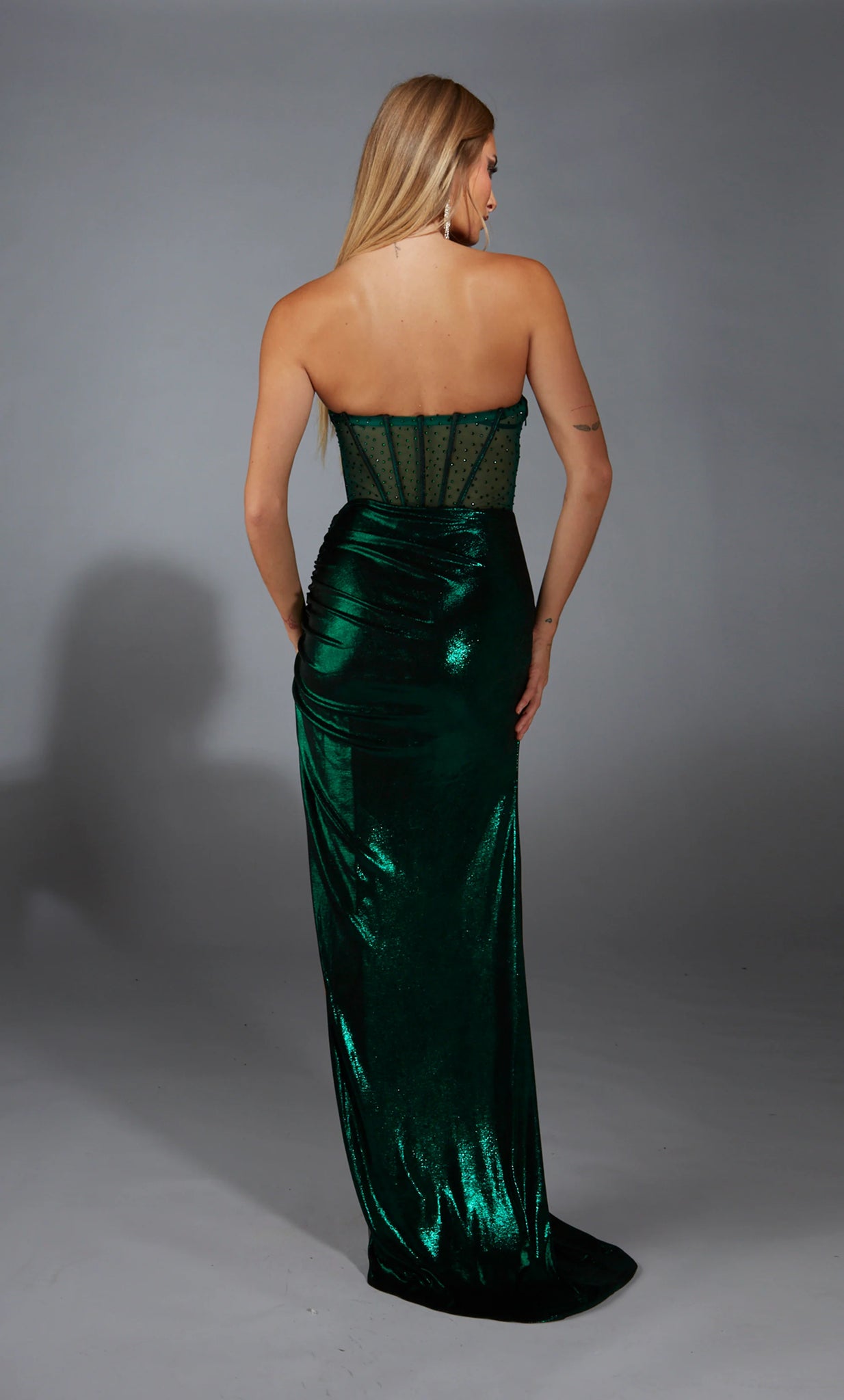 Catch the attention of all as you appear in the memorable long dress 61784 by Alyce Paris. The scoop strapless neckline is paired with a see through bodice beautifully adorned with hot stones. Showcasing the jersey made skirt displaying a liquid metallic affect to have you setting the trend of the season.