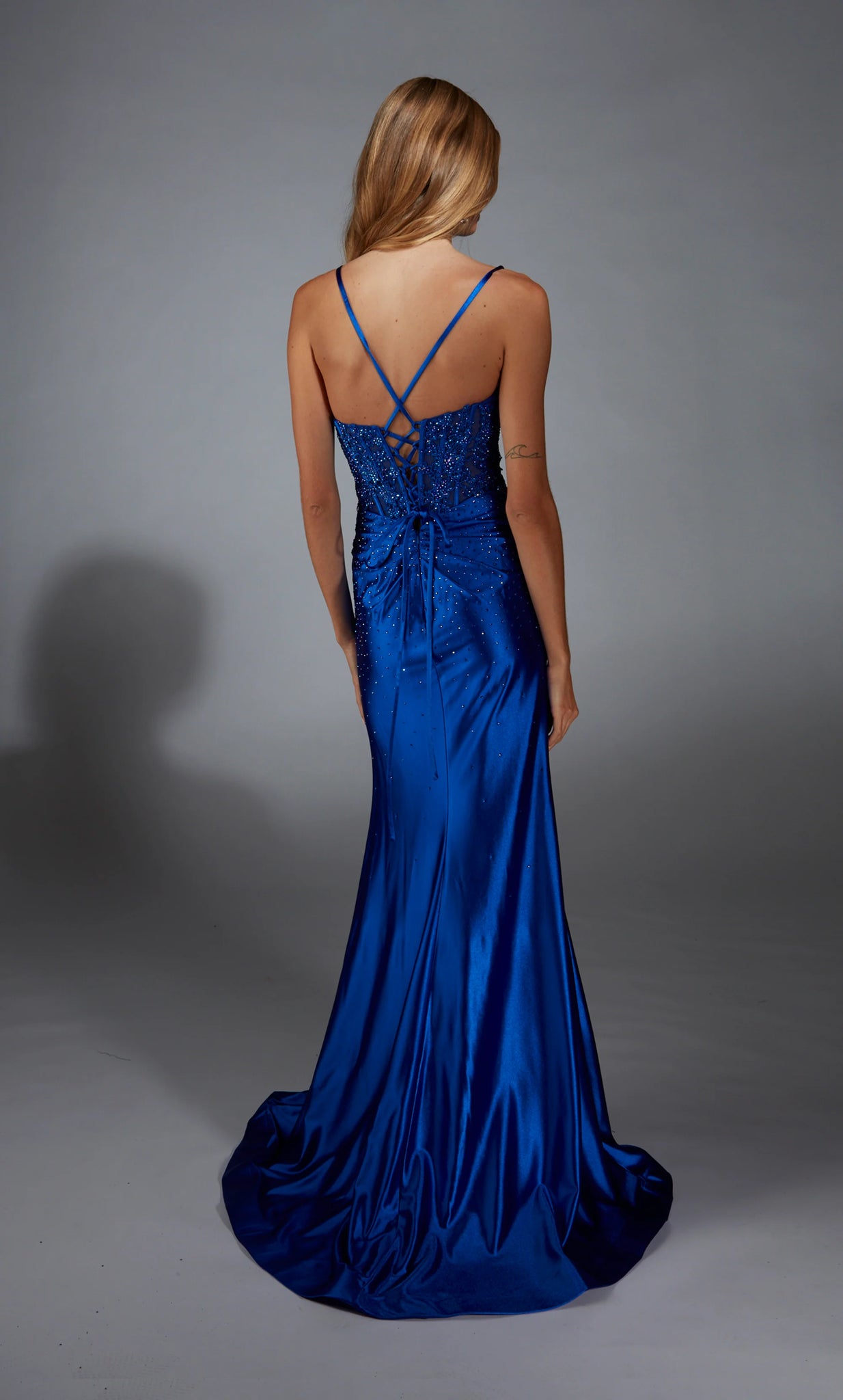 The statement dress of the season style 61827 by&nbsp;Alyce&nbsp;will have everyone doing a double take. The sweetheart neckline is combined with a a corset lace up back embellished with lace applique and adorned beautifully in meticulously placed glistening hot stones that sparsely cascaded down the fitted satin skirt for the perfect amount of illumination to your photos.