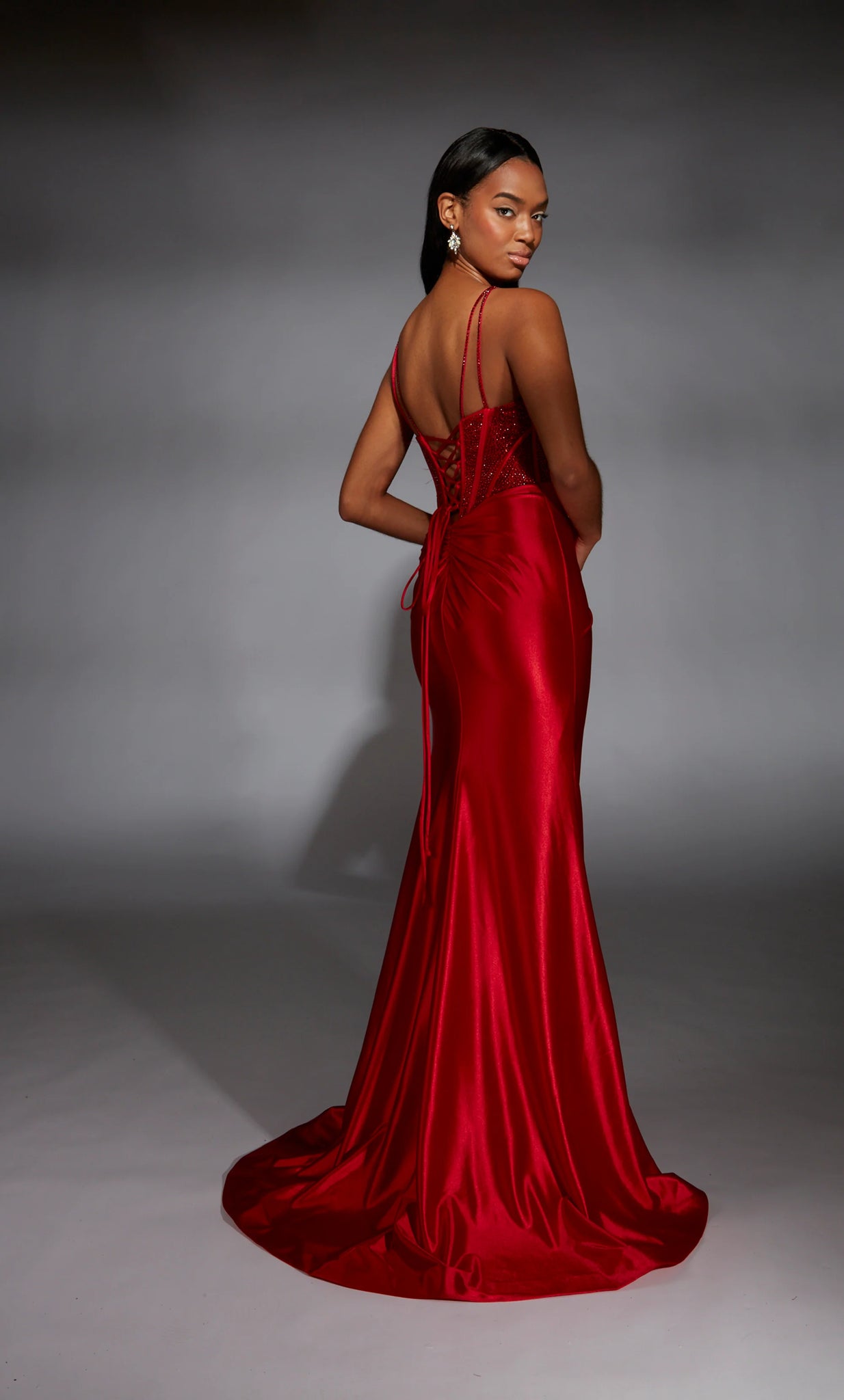 Rock this fashion forward long style 61832 by Alyce Paris . The sweetheart neckline is paired with an illusion corset bodice adorned tastefully in glistening hot stones. Showcasing the stretch satin skirt that will hug and shape effortlessly is followed by a thigh high slit and fly away train to follow you upon your entrance and exit.