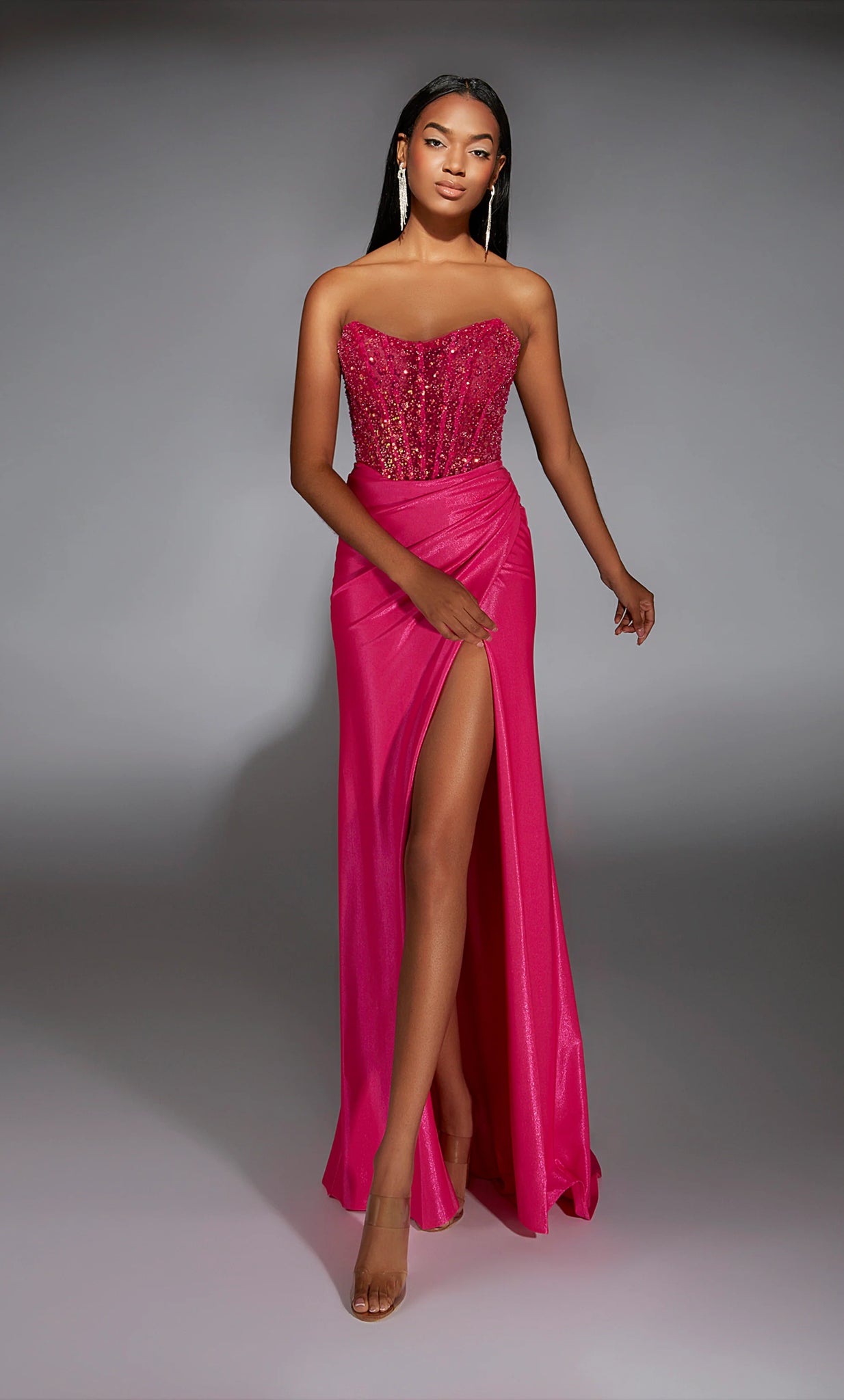 Draw the attention of the crowd as you walk the Prom stage wearing the sensational long style 61884 by Alyce Paris. The scoop neckline is paired with an illusion bodice displaying exposed boning and beautifully embellished with glistening beadwork all along the top. Headlining the jersey fitted skirt detailed with ruching along the midsection and lower backside. Followed by the perfect flyaway train.