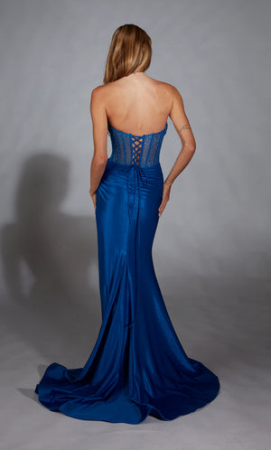 Strike a pose when wearing this beautiful long fitted dress from Alyce Paris style 61882. Consists of a soft V-neckine and see through lace up back corset bodice. The bodice is adorned in by sparkling bead work and exposed boning. Transitions into a jersey material fitted skirt with a side high thigh slit.