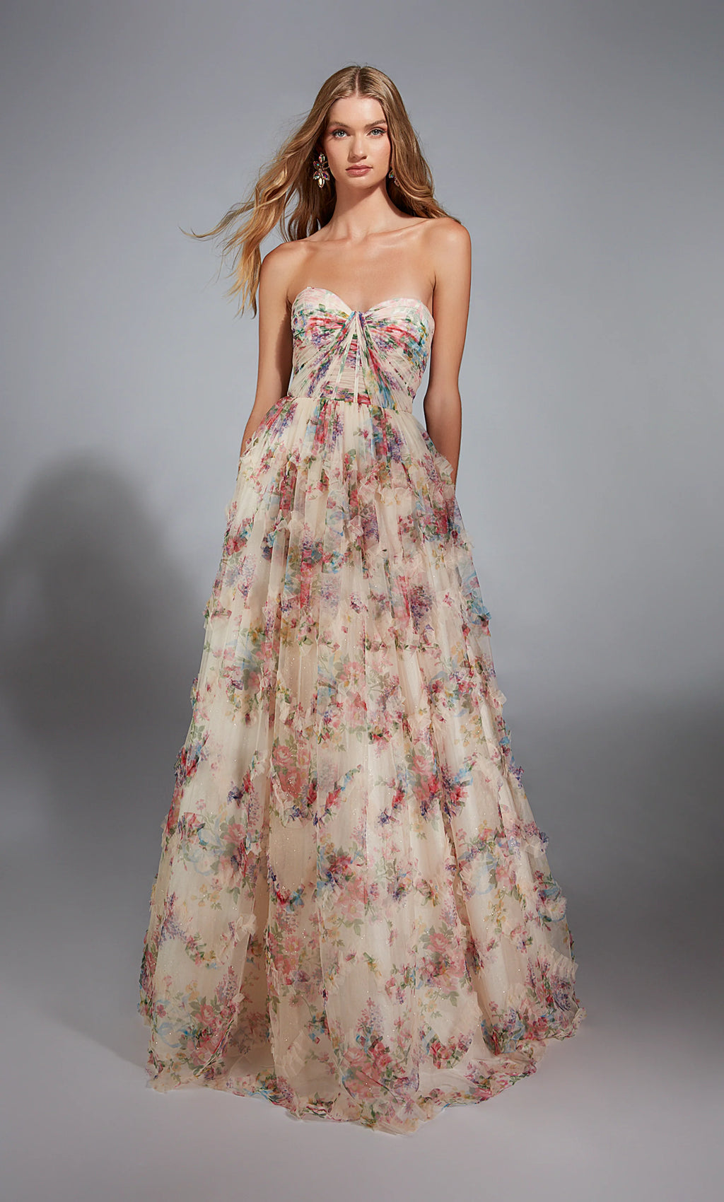 This gorgeous long A line gown is sure to have all eyes on you by Alyce Paris style number 61957. This lovely dress features a classic strapless sweetheart neckline with ruching on the bust and exposed boning. The bodice transitions seamlessly into the voluminous skirt where it has cute ruffles all over.