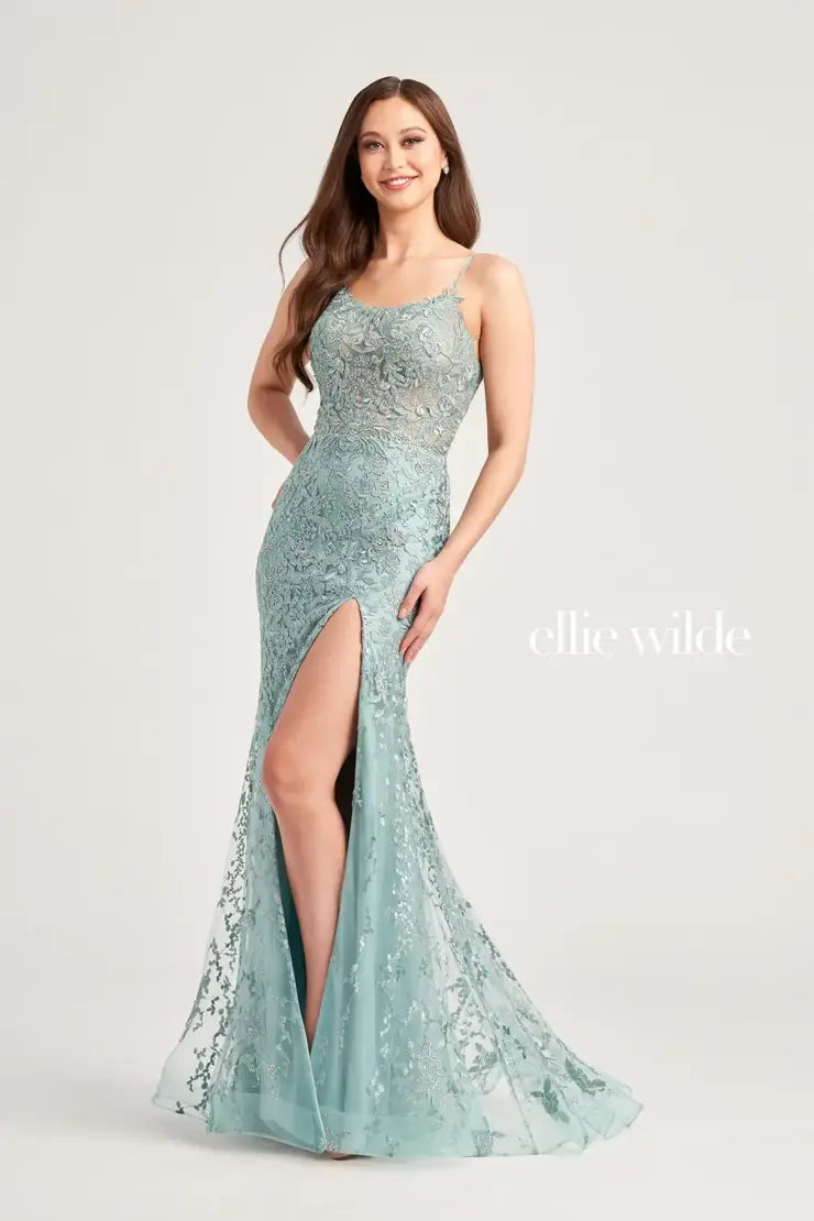 Exude confidence in this remarkable Ellie Wilde gown EW35223. Astonishing and exuberant, this shimmering dress features an edgy scoop neckline and dainty shimmering thin straps. Flattering on all, this enchanting gown accentuates your waistline highlighting your hourglass silhouette. Gleaming delicate lace embroidery adorns the entire silhouette giving this dress the perfect pop of glitz. The fitted long skirt showcases a high appealing slit that adds an alluring touch.