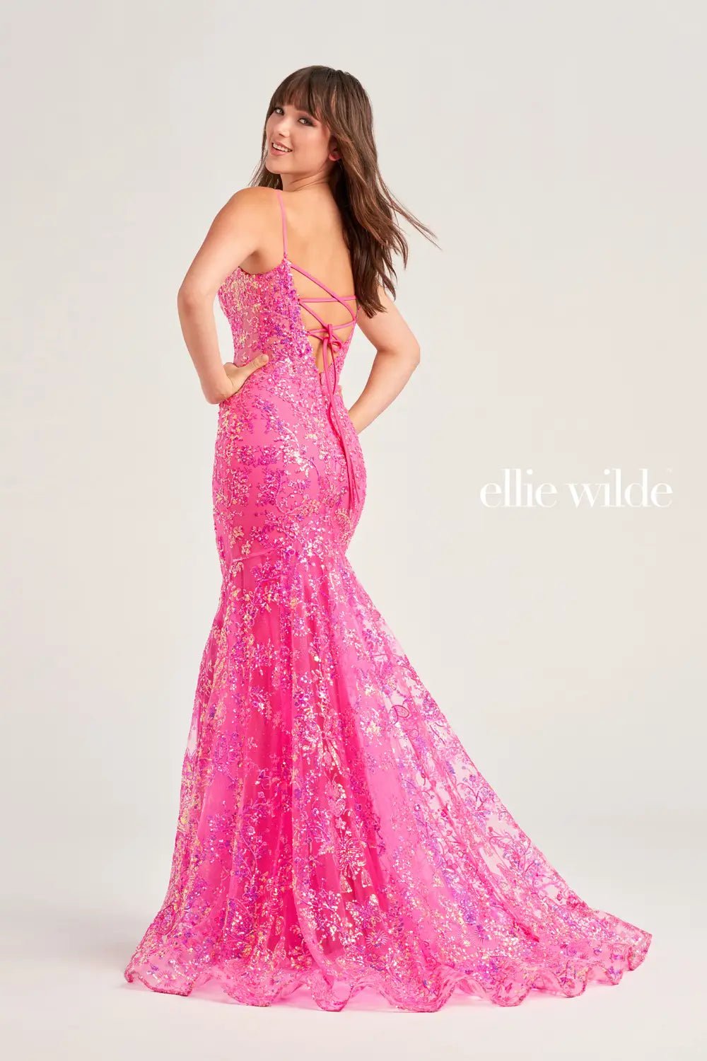 Show off your figure when you wear this body con fitted silhouette by Ellie Wilde style EW35013. This mesmerizing dress features a lovely v neckline with simple straps and eye catching lace up open back. Stunning embroidery and soft glitter tulle covers this number from top to bottom ensuring all heads turn towards you.