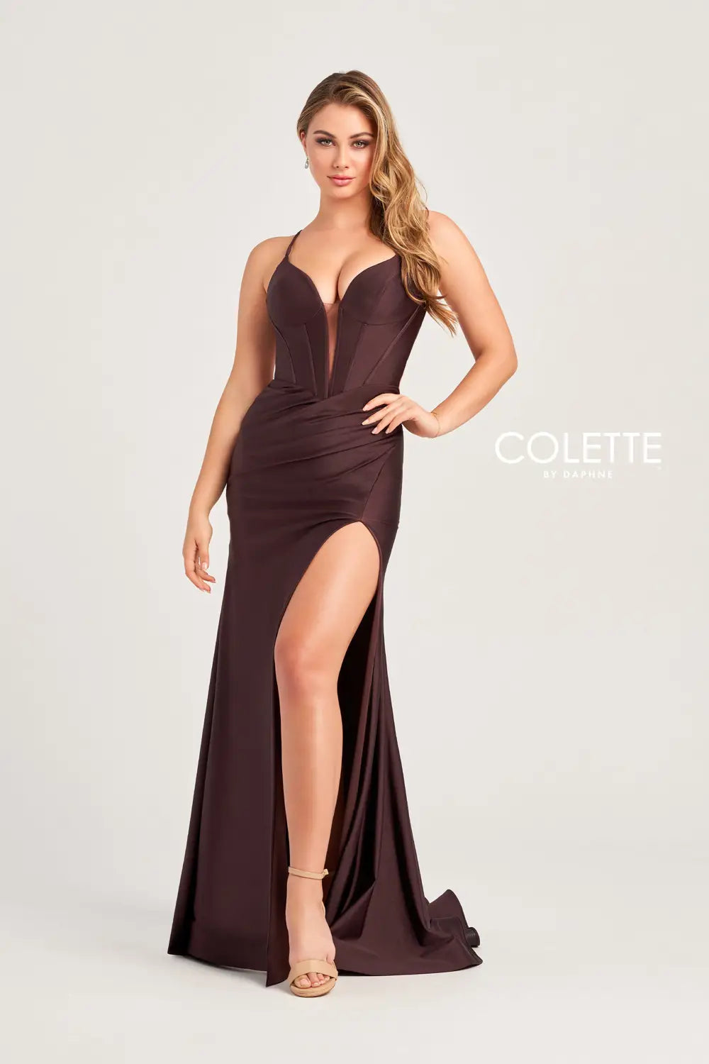 Be bold at your prom and get noticed in this glamorous Colette long dress style CL5204 made in hot colors of stretch jersey fabric. This sleek silhouette features a corset bodice with exposed boning, V neckline, spaghetti straps and large keyhole cutout back. The long curve hugging skirt has a high front side slit, horsehair hem edge and sweep train.