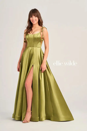 Turn heads when walking into prom with this long class dress by Ellie Wilde, style EW35215. This dress has a scoop neckline, a formal corset, graceful satin material, and a slit all in one. On top of everything, this dress comes with pockets that will ensure you to feel both comfortable and glamorous.