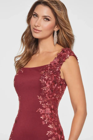 This gown exudes understated elegance. The softly structured bodice is beautifully adorned with delicate floral lace appliqué to highlight your waistline. The timeless bateau neckline and chic cap sleeves bring classic charm, while the fit-and-flare silhouette perfectly flatters your figure, delivering a look that’s both sophisticated and stunning.