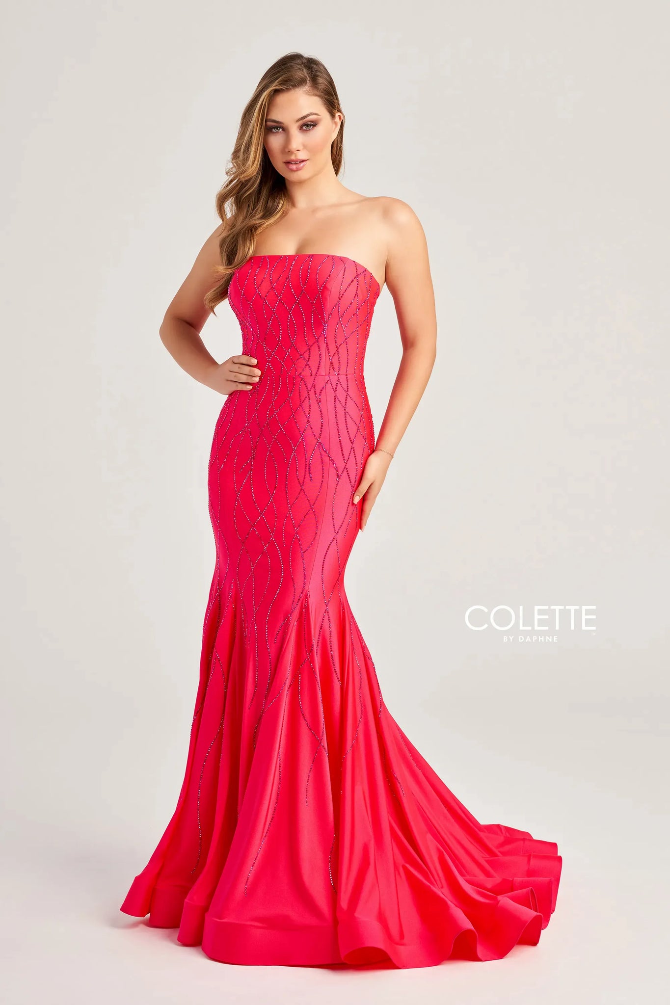 Flaunt your figure with this remarkable design by Colette CL5106. Designed with jersey fabric, this masterpiece mesmerizes in a strapless neckline with a formfitting bodice paired with a corset lace up back and rushing detail throughout the back zipper. The gown is detailed with beaded pattern throughout the entire dress and is completed with a stunning mermaid skirt and a sweeping train.