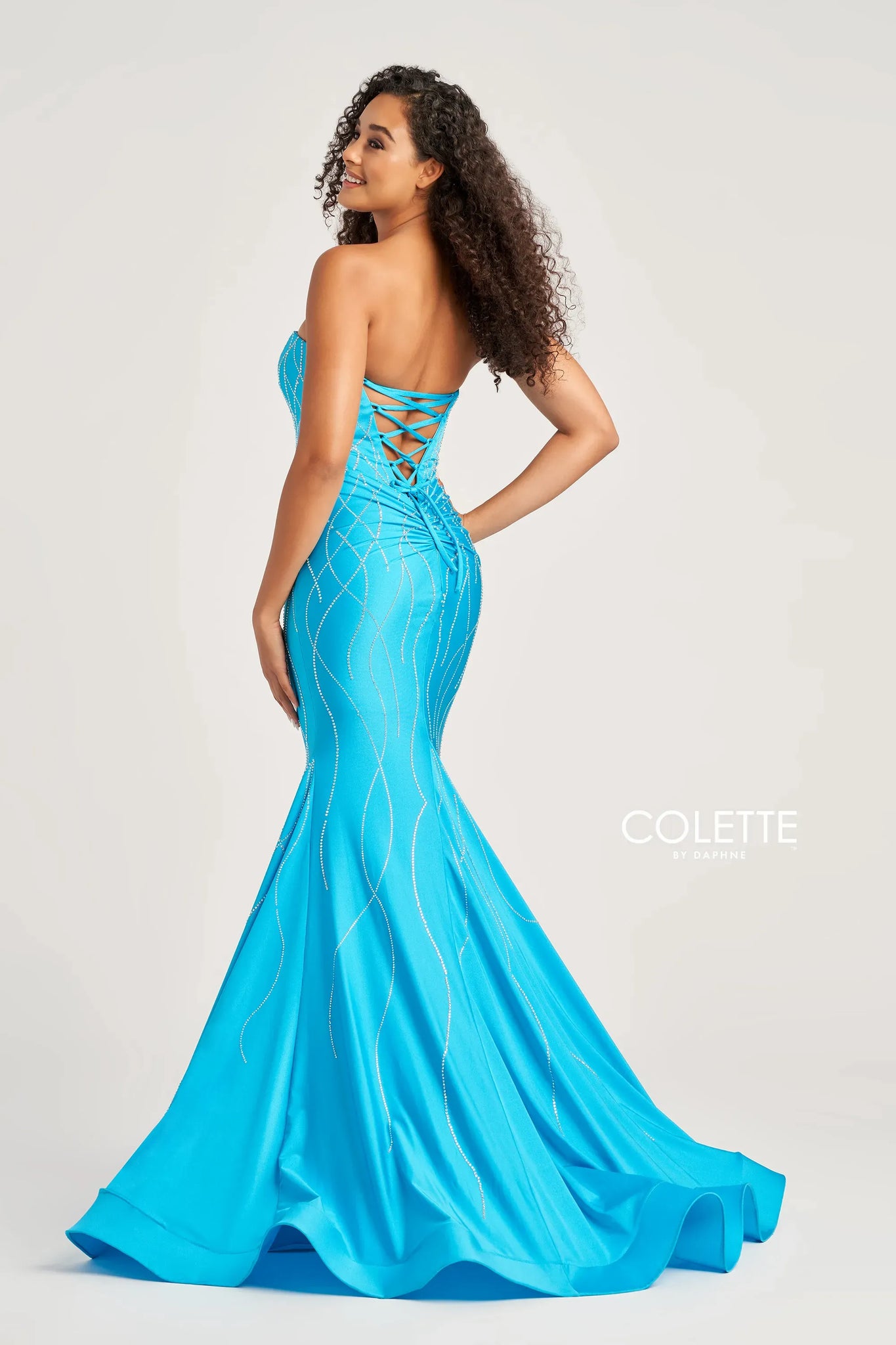 Flaunt your figure with this remarkable design by Colette CL5106. Designed with jersey fabric, this masterpiece mesmerizes in a strapless neckline with a formfitting bodice paired with a corset lace up back and rushing detail throughout the back zipper. The gown is detailed with beaded pattern throughout the entire dress and is completed with a stunning mermaid skirt and a sweeping train.