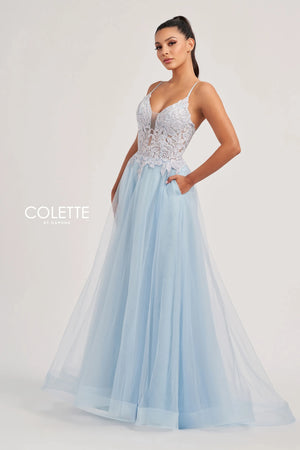 Feel like a star in this glamorous long dress by Colette, style CL8100. This lovely A line dress features a V neckline with thing straps, and a striking corset bodice adorned with beadwork, lace detailing, and sexy open lace up back that gives you an enhanced figure. The light tulle skirt has a thigh high slit, a gorgeous train, and side pockets that add a chic extra touch.