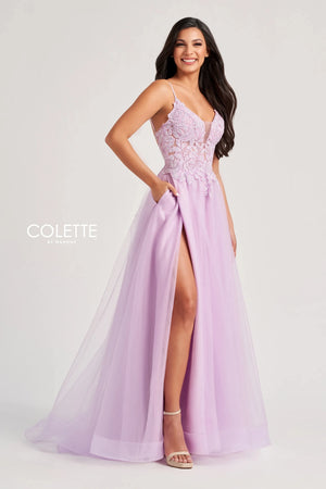 Feel like a star in this glamorous long dress by Colette, style CL8100. This lovely A line dress features a V neckline with thing straps, and a striking corset bodice adorned with beadwork, lace detailing, and sexy open lace up back that gives you an enhanced figure. The light tulle skirt has a thigh high slit, a gorgeous train, and side pockets that add a chic extra touch.