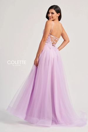 Feel like a star in this glamorous long dress by Colette, style CL8100. This lovely A line dress features a V neckline with thing straps, and a striking corset bodice adorned with beadwork, lace detailing, and sexy open lace up back that gives you an enhanced figure. The light tulle skirt has a thigh high slit, a gorgeous train, and side pockets that add a chic extra touch.