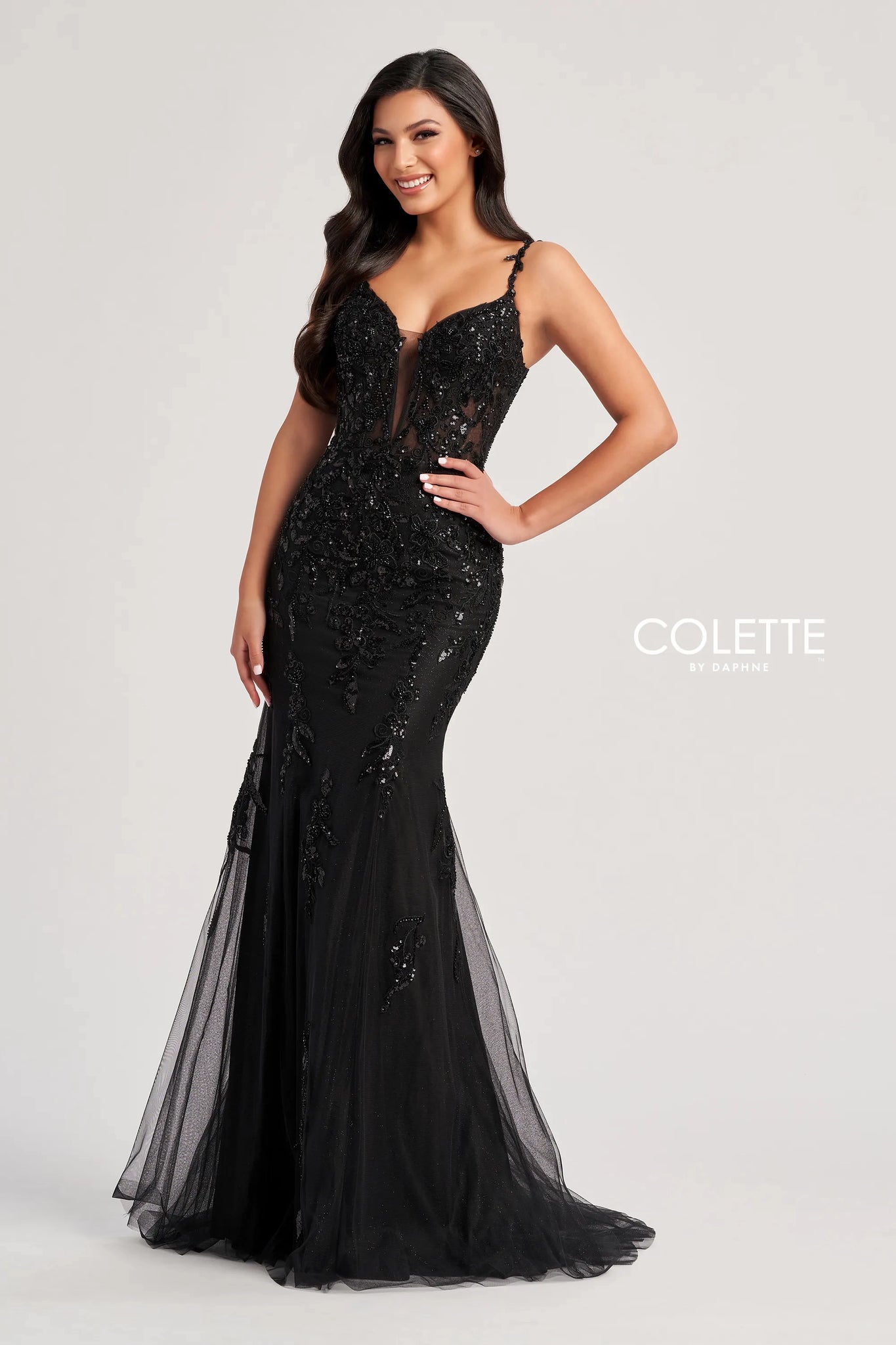 Feel classy and elegant when wearing this long&nbsp;fitted dress&nbsp;by Colette, style CL8210. Showcasing a plunging v- neckline with delicate straps leading to a sexy open corset lace up back that will hug your bodice beautifully all time. This ensemble has a unique see through corset top that's fully adorned with floral applique and dazzling beadwork. The bottom it's a straight fitted glitter tulle skirt that's fully embellished with glistening sequins designs. To amp up the drama it has a classy train.