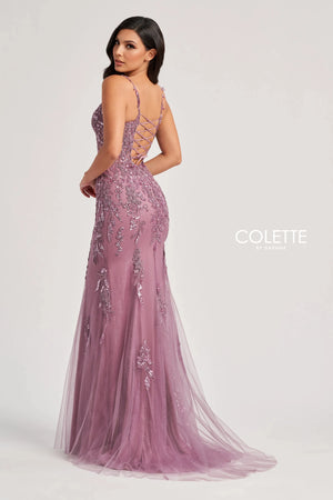 Feel classy and elegant when wearing this long&nbsp;fitted dress&nbsp;by Colette, style CL8210. Showcasing a plunging v- neckline with delicate straps leading to a sexy open corset lace up back that will hug your bodice beautifully all time. This ensemble has a unique see through corset top that's fully adorned with floral applique and dazzling beadwork. The bottom it's a straight fitted glitter tulle skirt that's fully embellished with glistening sequins designs. To amp up the drama it has a classy train.