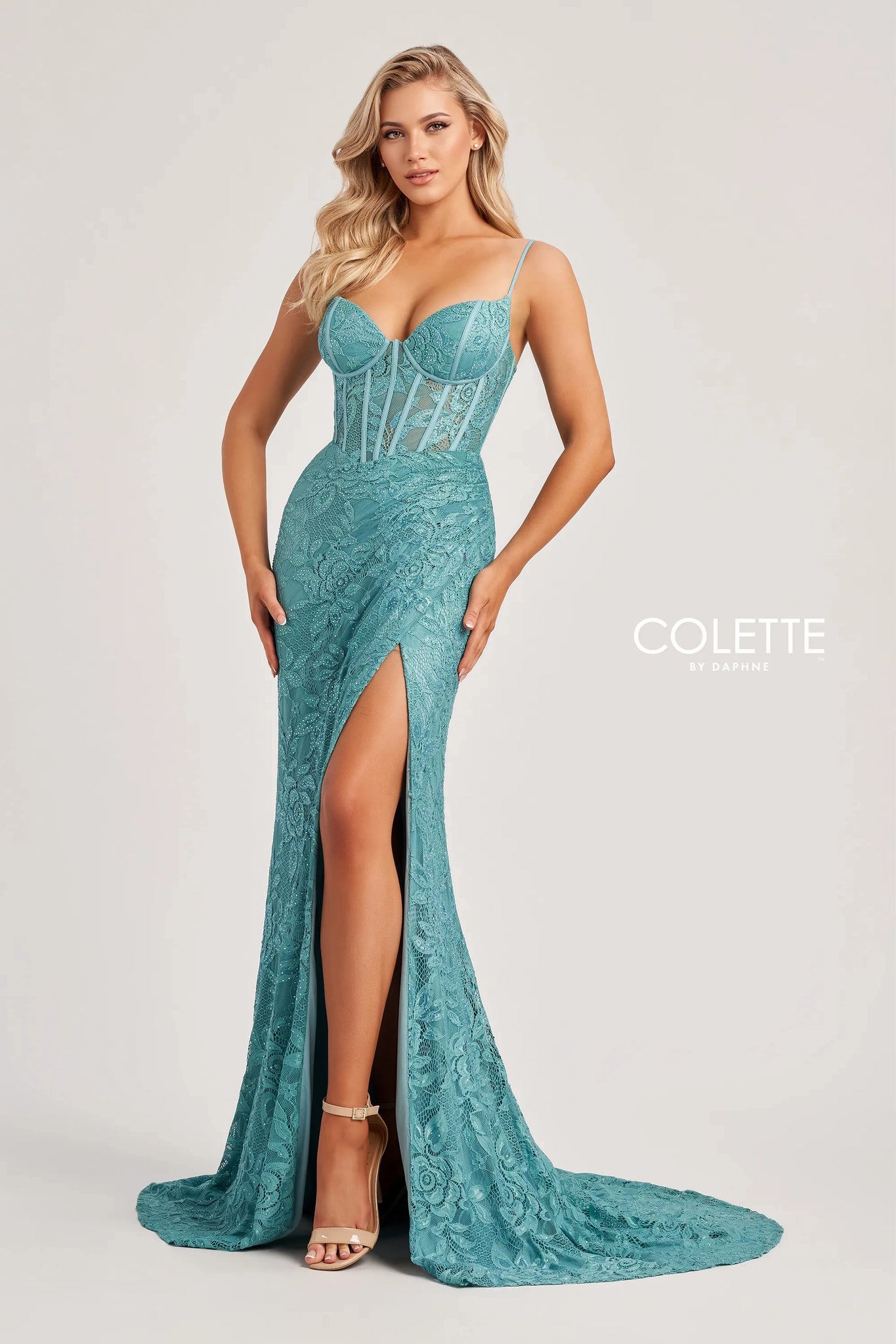 Make heads turn when wearing this long lace fitted dress by Colette, style CL8405. This ensemble has a modern v- neckline with delicate thin straps leading to a unique sexy open corset lace up back that will hug your body beautifully ending with a back zipper back. Showcasing a beautiful silhouette that will hug your body gorgeously at all times. The bottom of this dress has a classy slit and a simple train. Adorned with glistening beadwork and unique floral novelty material.