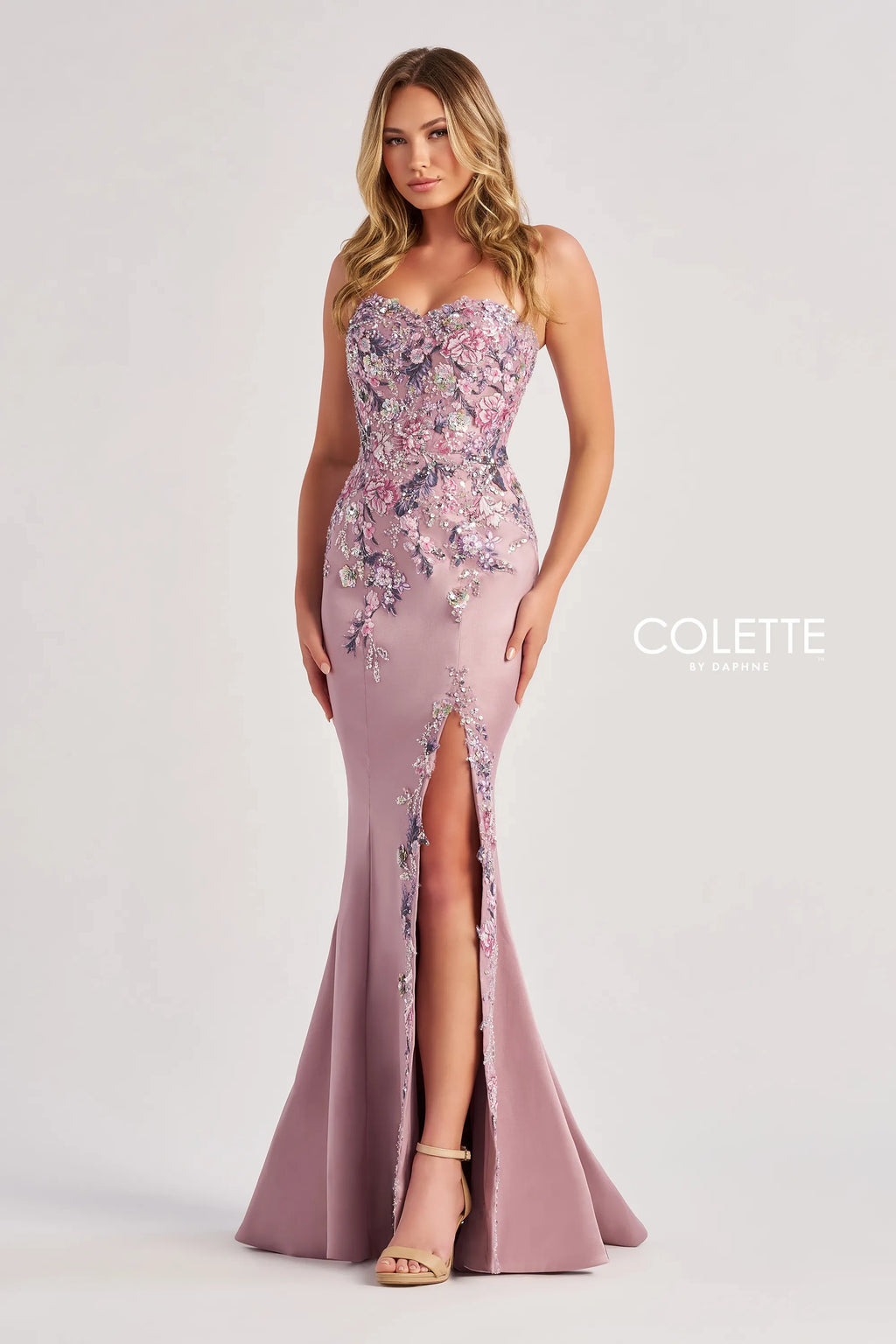 Amp up the drama when wearing this phenomenal long fitted mikado dress by Colette, style CL8410. Showcasing a strapless sweetheart neckline that comes with detachable spaghetti straps. This ensemble is had a beautiful bodice that will hug your waist gorgeously all time. Fully adorned with floral applique and unique beadwork going down the dress. For the perfect final touch it has a classy slit.