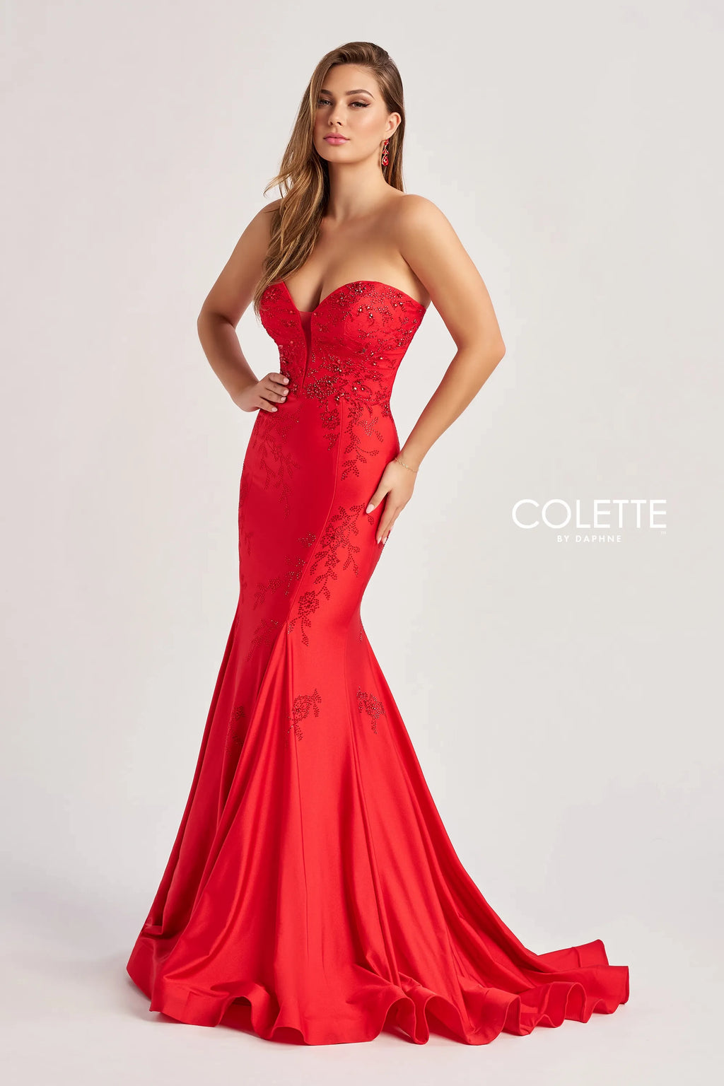 Strike a pose in this chic long dress by Colette style, CL8445. Showcasing a fitted mermaid silhouette with a strapless sweetheart neckline, that comes with detachable spaghetti straps. This number is made out of jersey material. It has glistening beadwork that cascades down the dress. A corset lace up back is sure to snatch you in.