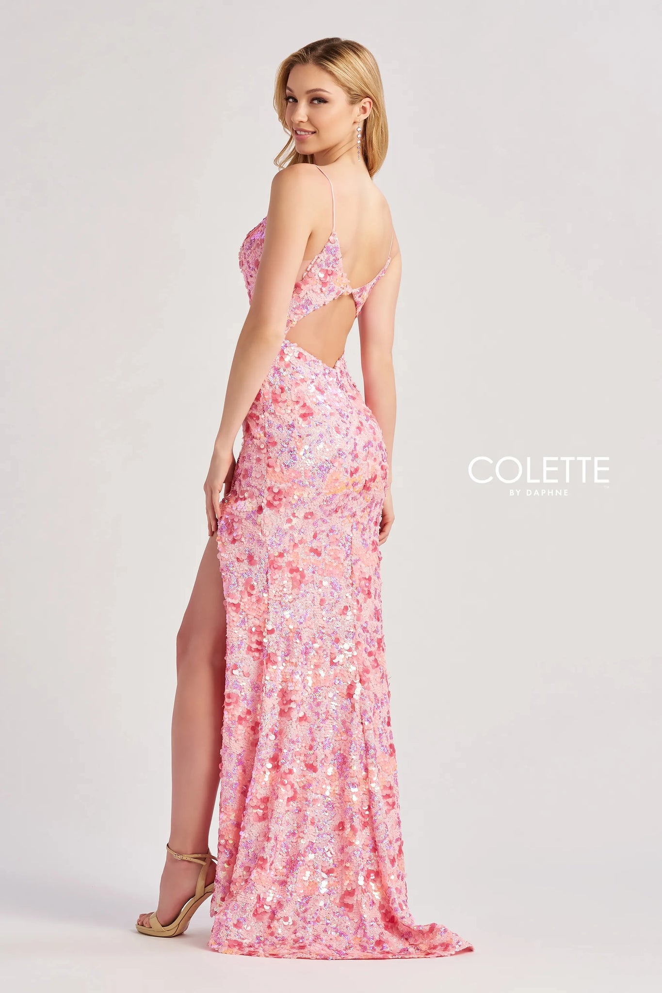 Strike a pose in this fabulous long dress by Colette, style CL8465. Featuring a fitted silhouette with a modest v neckline that has delicate straps that lead to a gorgeous open back. This number is fully adorned with glistening sequins and dazzling beadwork thats sewn in an intricate pattern. A thigh high slit is the perfect final touch.