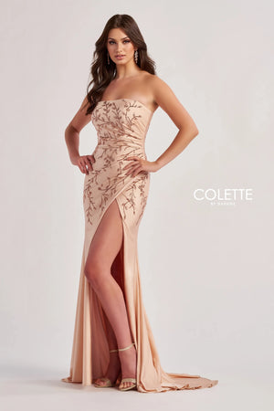 Feel like you just step foot off the red carpet in this gorgeous long dress by Colette, style CL8500. Showcasing a fitted silhouette with a strapless scoop neckline. This number is made out of jersey material that hugs the curves gorgeously. This number is adorned with glistening beadwork that cascades down the dress. A thigh high slit is the perfect final touch.