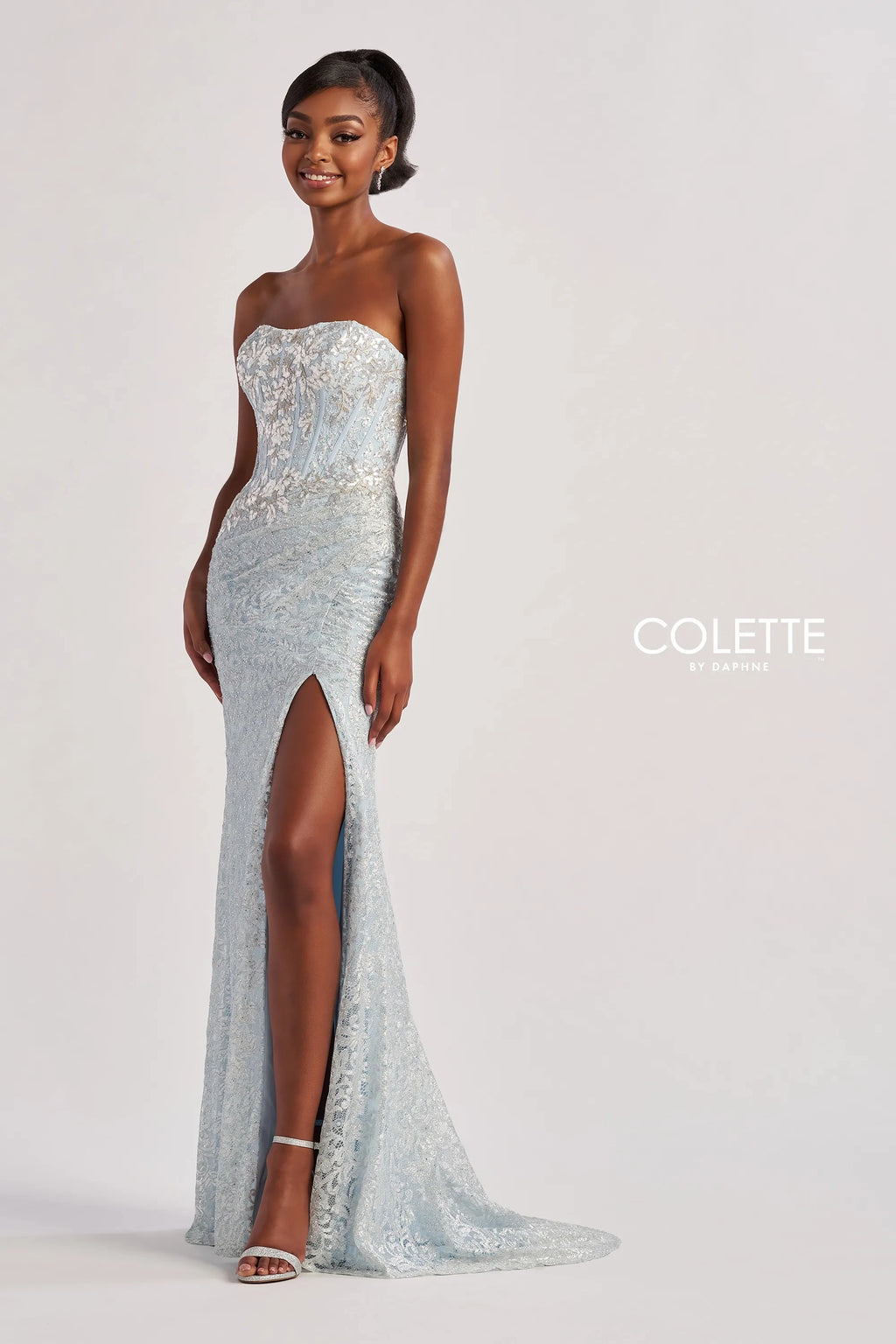 Have all eyes on you when wearing this phenomenal long dress by Colette, style CL8595. Showcasing a strapless modern neckline that comes with detachable straps leading to a sexy open corset lace up back that will hug your waist beautifully. Adorned with dazzling beadwork. The bottom is made out of stretchy lining lace material. Fully embellished with glistening sequins throughout the ensemble. For the perfect final touch it has a classy slit and a gorgeous train.