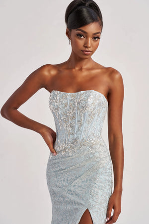 Have all eyes on you when wearing this phenomenal long dress by Colette, style CL8595. Showcasing a strapless modern neckline that comes with detachable straps leading to a sexy open corset lace up back that will hug your waist beautifully. Adorned with dazzling beadwork. The bottom is made out of stretchy lining lace material. Fully embellished with glistening sequins throughout the ensemble. For the perfect final touch it has a classy slit and a gorgeous train.