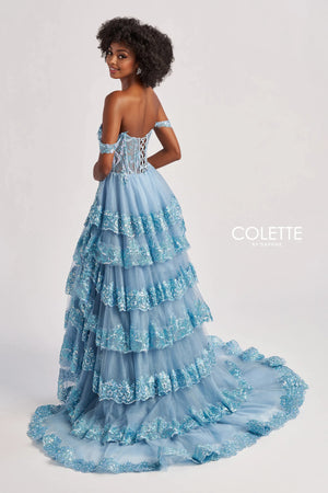 Make a glamorous entrance at your next special event in this stunning A line gown by Colette style CL8690. Showing an off the shoulder neckline adorning the fitted flattering corset bodice. A line skirt is adorned with a multi layered effect and beautiful thigh high slit and a stunning long sweep train.