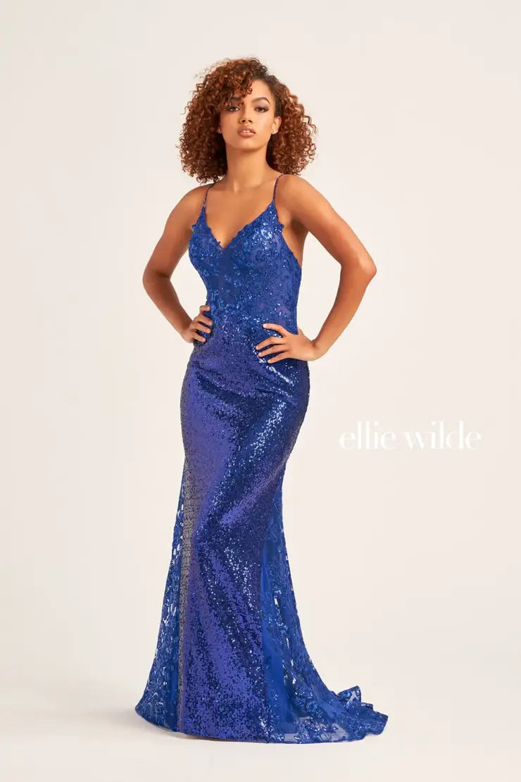 Enhance your sparkle as you step onto prom with this fabulous dress by Ellie Wilde, style EW35202. This glittery dress will have you feeling like a super model as it has a luxurious long train and a sharp looking v-shaped neckline. The open back on this dress is just one way that will have you feeling like the main focus of the night.