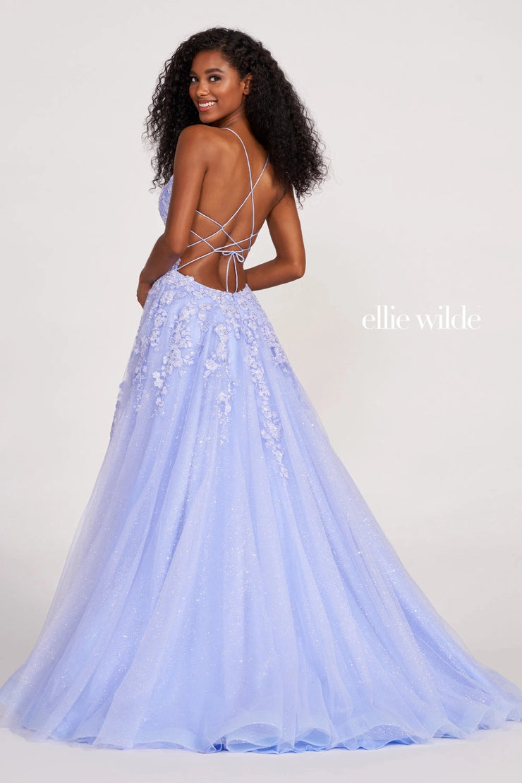 Shine bright like a diamond in captivating long dress EW34053 by Ellie Wilde. This dress is perfect for any girl who wants to sparkle throughout the night. The A line silhouette consists of a fitted bodice along with a flared out skirt that enhances your figure. Dazzling lace and appliques adorn the bodice giving it the perfect amount of sparkle and detail while making a lovely transition onto the voluminous glittering tulle skirt. Move freely with a classic thigh high slit and adjustable lace up closure.