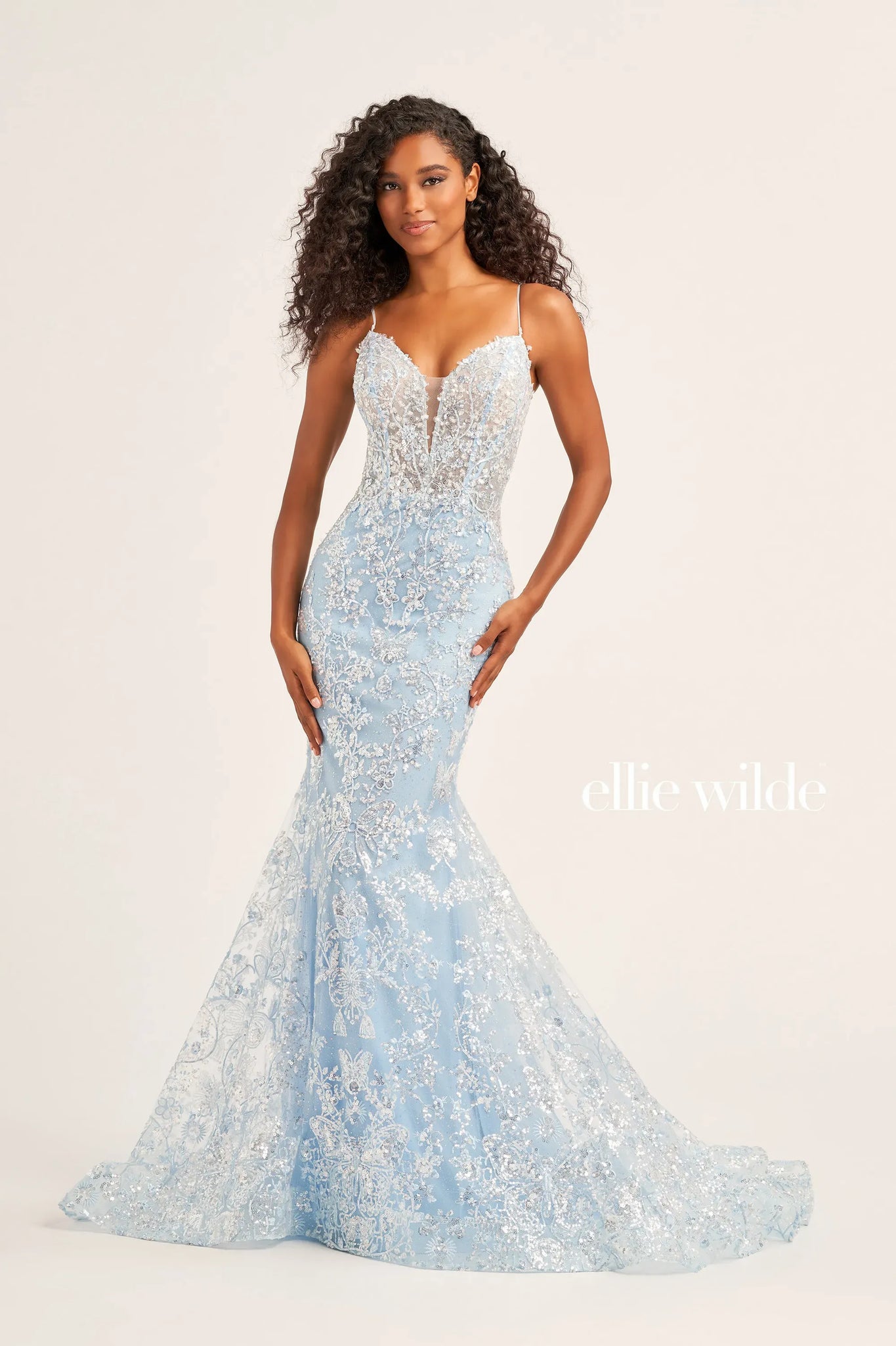 Show off your figure when you wear this body con fitted silhouette by Ellie Wilde style EW35013. This mesmerizing dress features a lovely v neckline with simple straps and eye catching lace up open back. Stunning embroidery and soft glitter tulle covers this number from top to bottom ensuring all heads turn towards you.