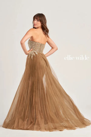 Look like you just stepped off the red carpet when you wear this one of a kind Ellie Wilde long prom dress EW35085. This fitted dress will effortlessly flatter your figure and features a strapless asymmetrical neckline along with a shark bite slit and sweep train that is enhanced by the organza overskirt.