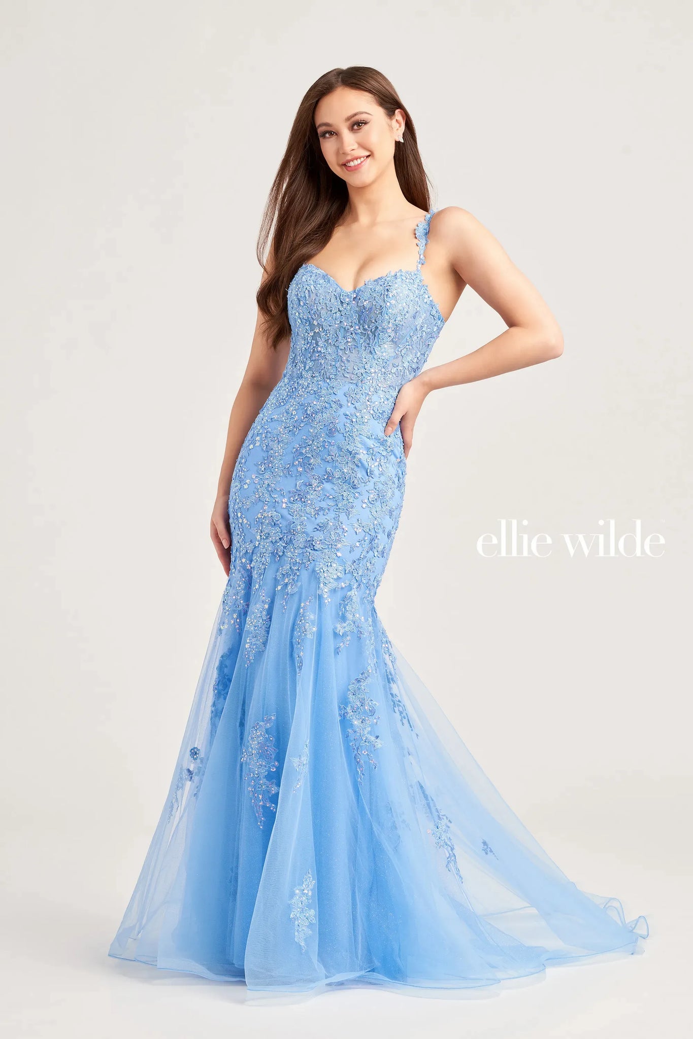 Exude elegance in this elegant Ellie Wilde fitted mermaid dress EW35238. The fitted silhouette is entirely garnished in glistening combinations of beads for an everlasting sparkle while the flowy glittering tulle sweep train follows gracefully behind you. The V-neckline is supported by embellished straps.