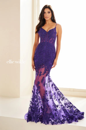 Showcasing the sophisticated long style EW36014 by Ellie Wilde. The illusion bodice is embellished with delicate lace applique that cascades down the trumpet skirt and scallops along the bottom of the fly away train. Headlining the detachable skirt liner to give you more than one look for your eventful evening.